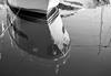 Black and white reflection of boat on water